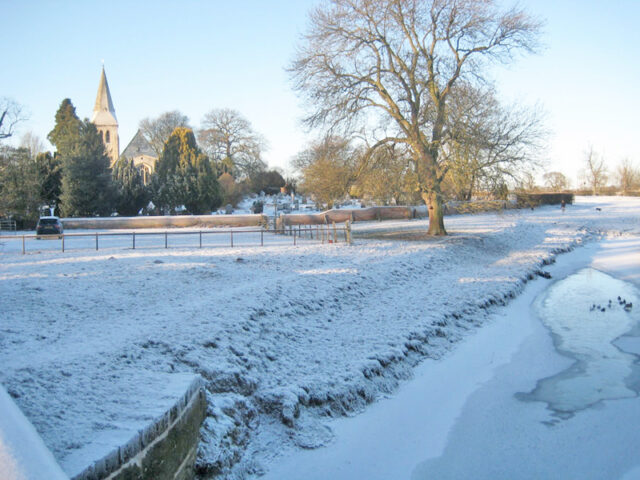 A frozen Foss with Huntington Church in the distance